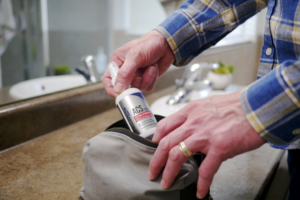 man pulls colloidal silver spray from bag to improve health