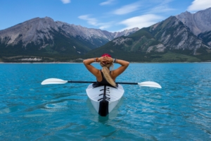 girl sun bathes in kayak to feel healthy during summer months