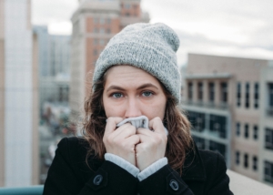 Woman protects her mouth and immune system from cold during winter months