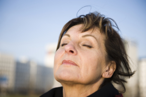woman with strong immune system breathes in fresh air