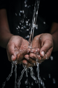 woman washes hands in hydrating water