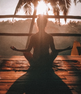 woman takes a break from working to do yoga