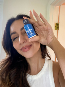 Woman holds Resteva Rx natural sleep supplement 