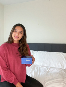 Girl holds box of Resteva Rx sleep aid formula