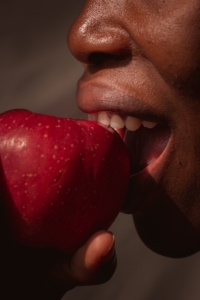 woman eats healthy fruit to boost her immune system and avoiding sickness