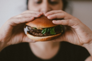 woman eats burger filled with toxins