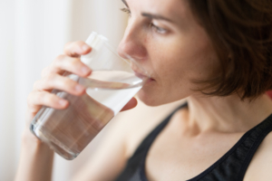 woman drinks water to detox