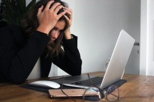 woman's stress effects her immune system as she works at computer