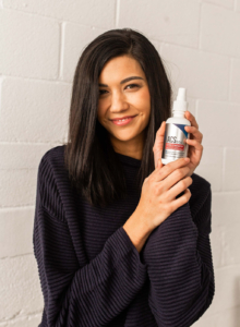 woman holds ACS 200 silver immune support spray