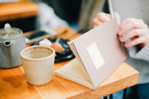 woman journals about her health in a journal