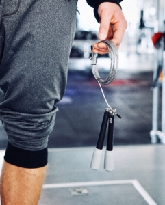 busy man holds jump rope for exercise 