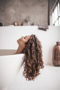 woman shows hair after using toxic hair products