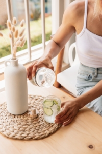 woman drinks water for hydration to support her immune system