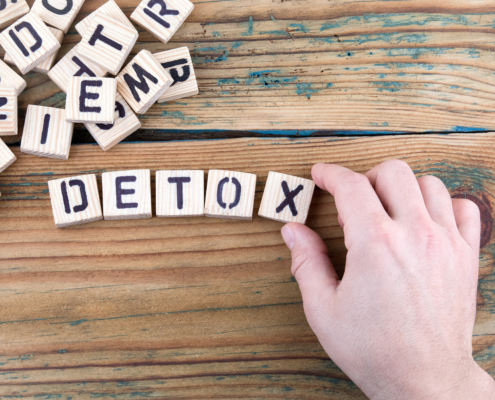 detox. Wooden letters on the office desk, informative and communication background.