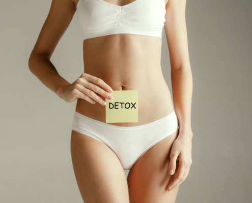 Female belly with drawing word DETOX. Metabolism, stomach, woman, health weight concept, body detox